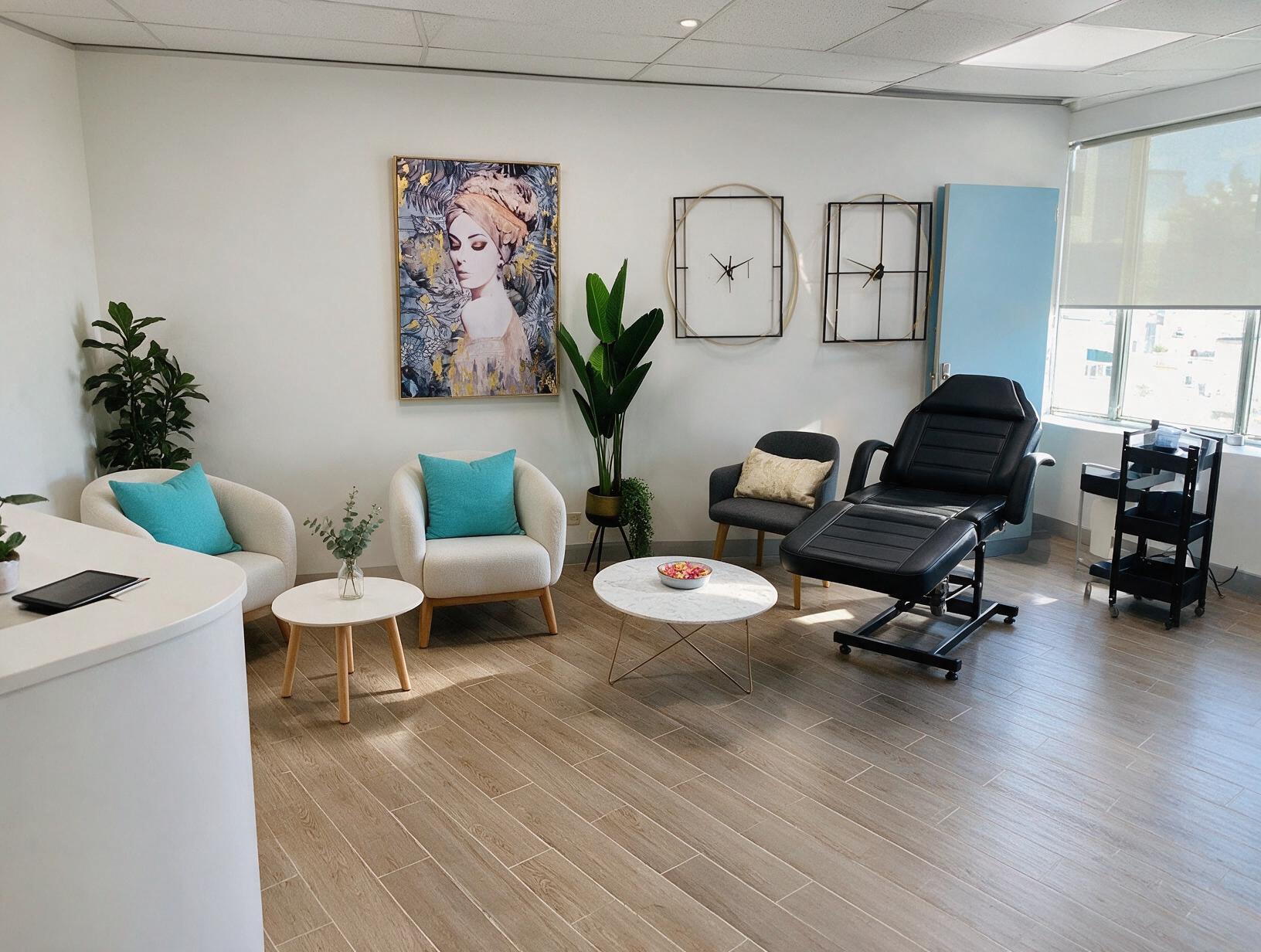 Bright, tidy treatment room with a black reclining chair, cream armchairs, marble coffee table, plants